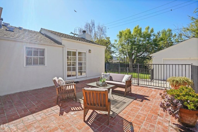 view of patio with an outdoor hangout area, an outdoor structure, and fence