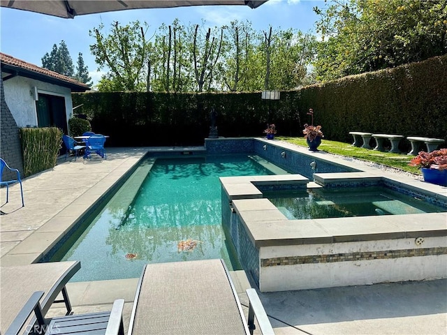 view of pool with a patio area, a fenced backyard, and a pool with connected hot tub