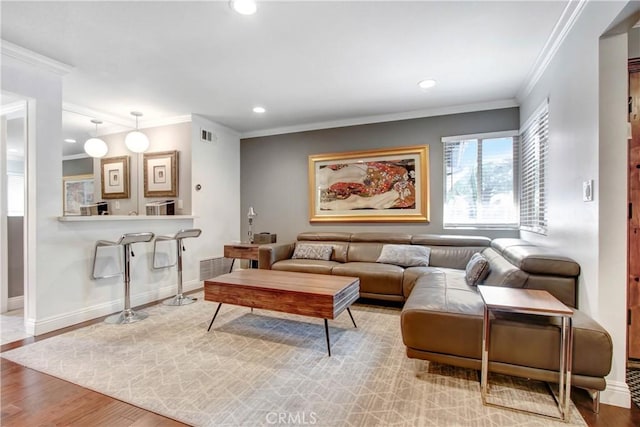 living room with ornamental molding, recessed lighting, wood finished floors, and baseboards