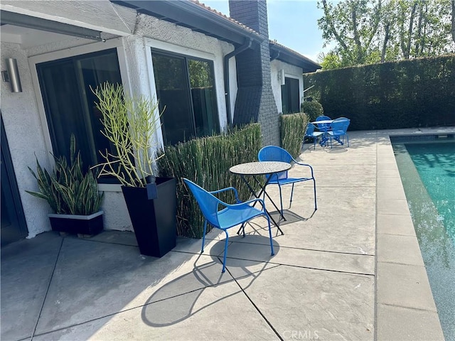 view of patio with fence and a fenced in pool