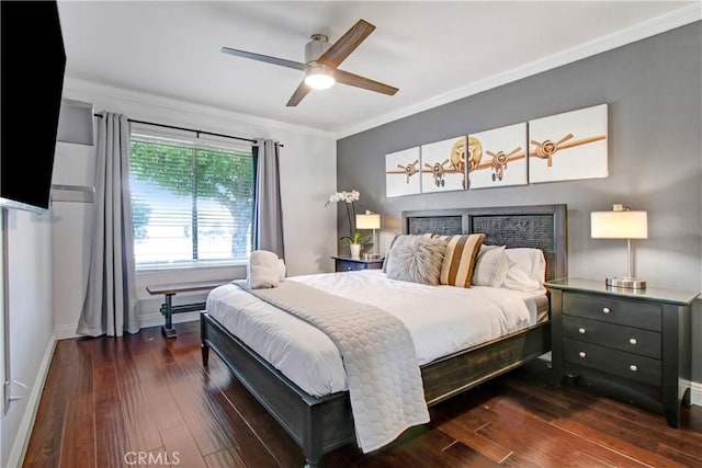 bedroom featuring ornamental molding, dark wood finished floors, baseboards, and a ceiling fan