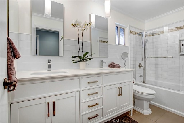 full bath with a sink, tile walls, and crown molding