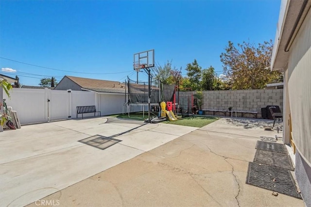 view of patio featuring a fenced backyard and a trampoline