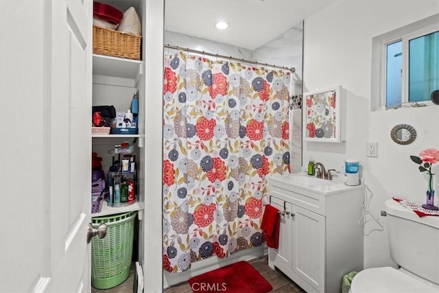 full bathroom with toilet, recessed lighting, and vanity