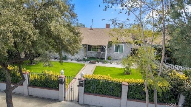 view of front of home featuring a fenced front yard, a shingled roof, a front yard, a gate, and stone siding