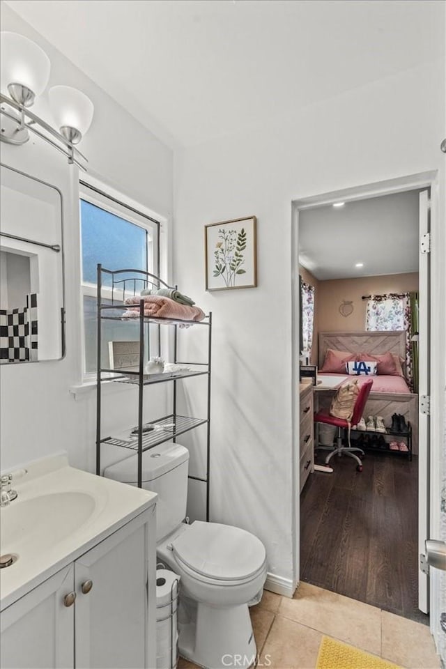 bathroom with vanity, tile patterned flooring, ensuite bath, and toilet