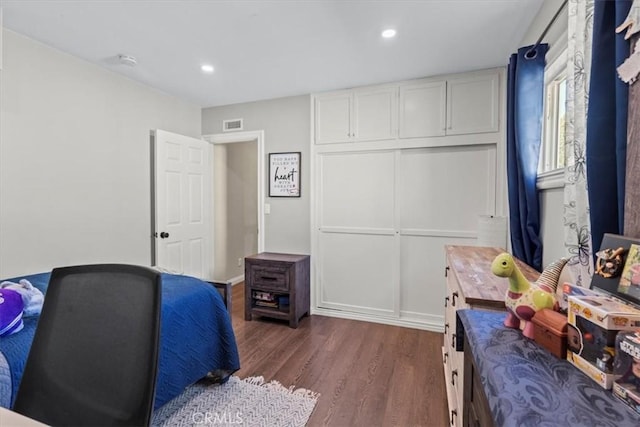 bedroom with dark wood-style floors, visible vents, and recessed lighting