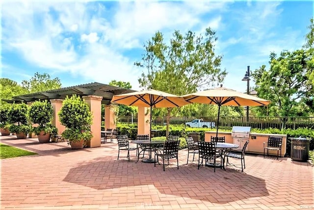 view of patio / terrace with area for grilling, a pergola, and fence