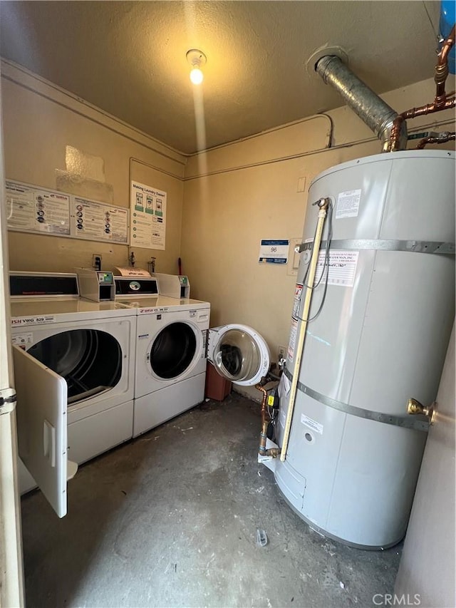 washroom featuring secured water heater, separate washer and dryer, and a textured ceiling