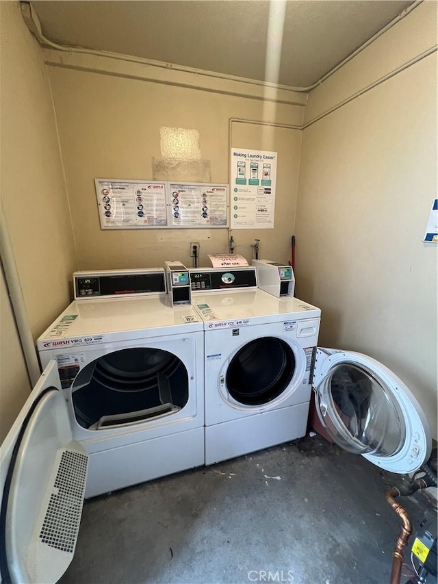 community laundry room featuring separate washer and dryer