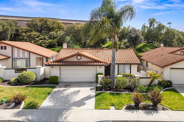 mediterranean / spanish-style house with driveway, a tiled roof, an attached garage, fence, and stucco siding