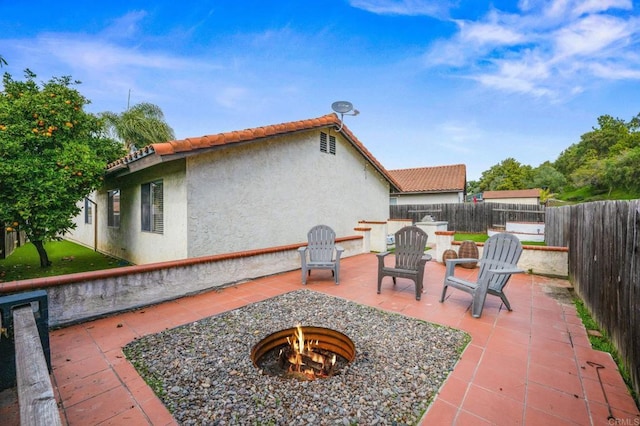 view of patio / terrace featuring a fenced backyard and a fire pit