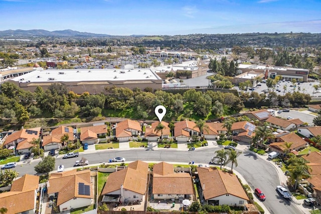 drone / aerial view featuring a residential view and a mountain view