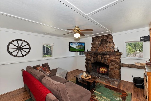 living room with ceiling fan, a fireplace, and wood finished floors