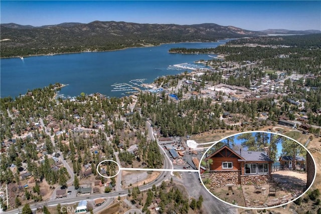 aerial view featuring a water and mountain view