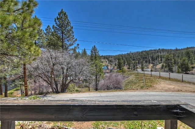 view of road featuring a wooded view