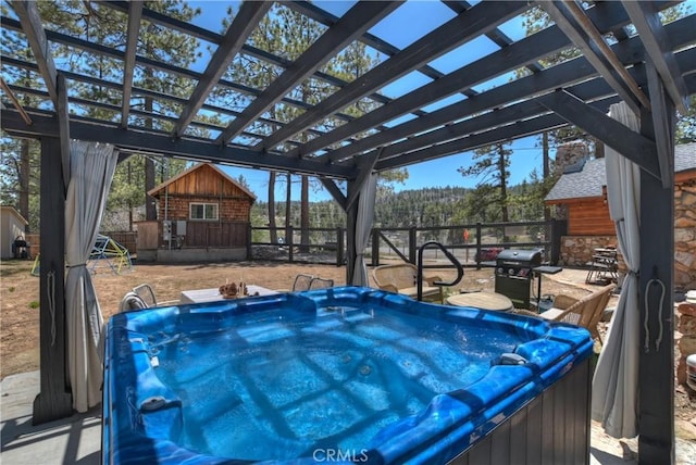 deck with an outbuilding, a hot tub, grilling area, and a storage unit