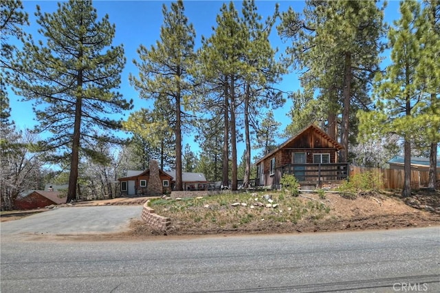 view of front of home featuring driveway and fence