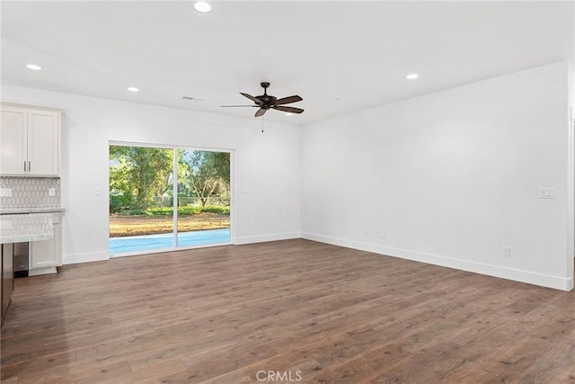 unfurnished living room featuring baseboards, wood finished floors, a ceiling fan, and recessed lighting