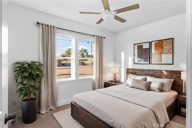 bedroom with ceiling fan and baseboards