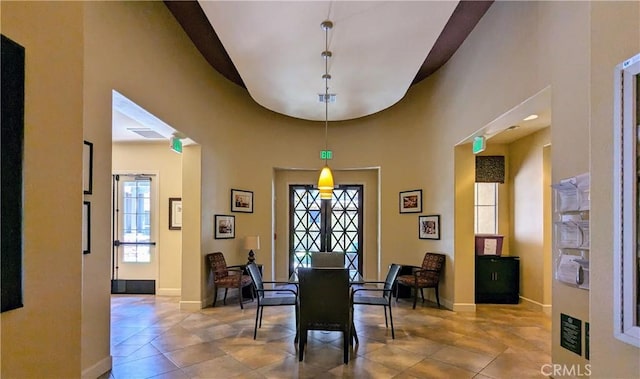 tiled dining space featuring baseboards