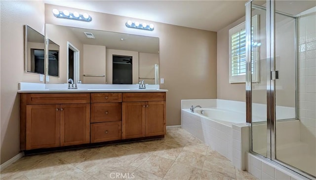 bathroom featuring a garden tub, double vanity, a stall shower, and a sink