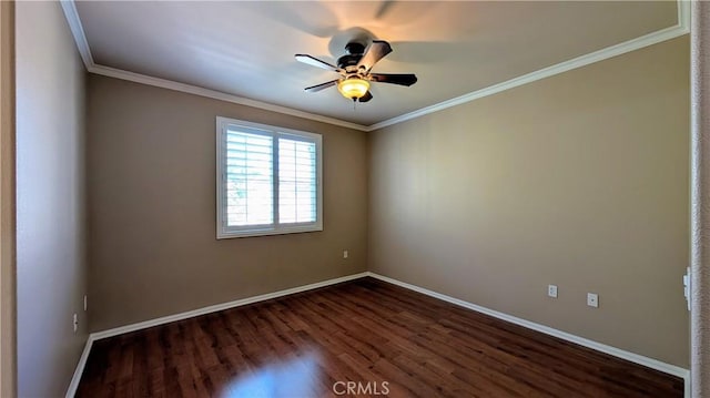 spare room featuring ornamental molding, dark wood-style flooring, ceiling fan, and baseboards