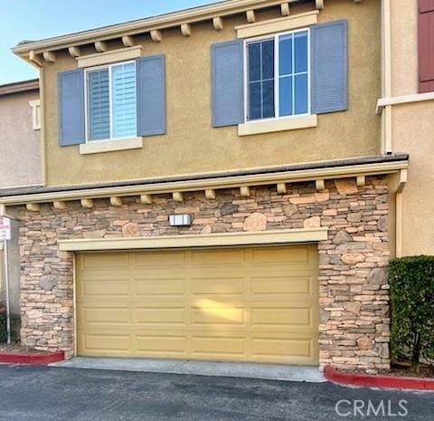 garage featuring aphalt driveway