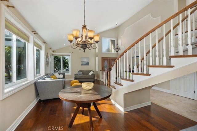 dining room with stairway, lofted ceiling, and wood-type flooring