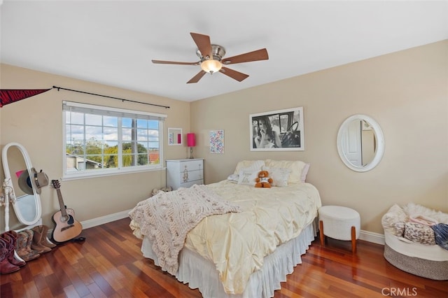 bedroom featuring baseboards, wood-type flooring, and ceiling fan