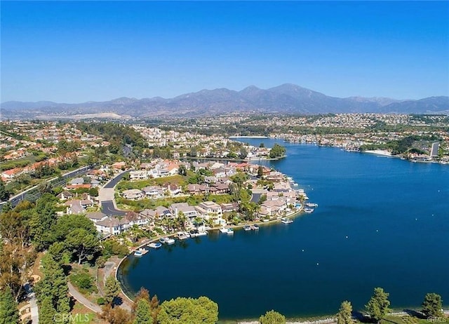 birds eye view of property featuring a water and mountain view