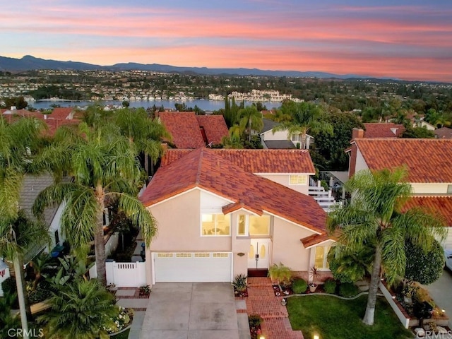 birds eye view of property featuring a water and mountain view