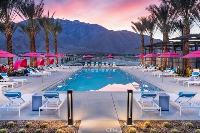 community pool featuring a mountain view and a patio