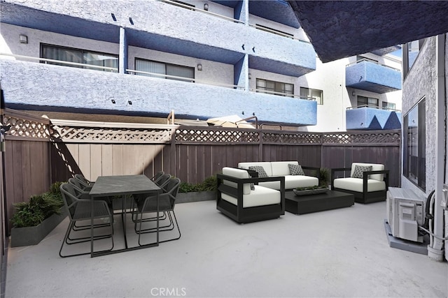 view of patio with outdoor dining area, a fenced backyard, and an outdoor living space