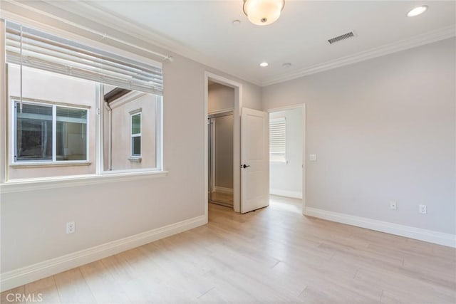 unfurnished bedroom featuring crown molding, recessed lighting, visible vents, wood finished floors, and baseboards