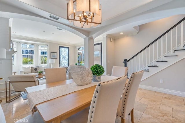 dining area with arched walkways, ornamental molding, visible vents, and a chandelier