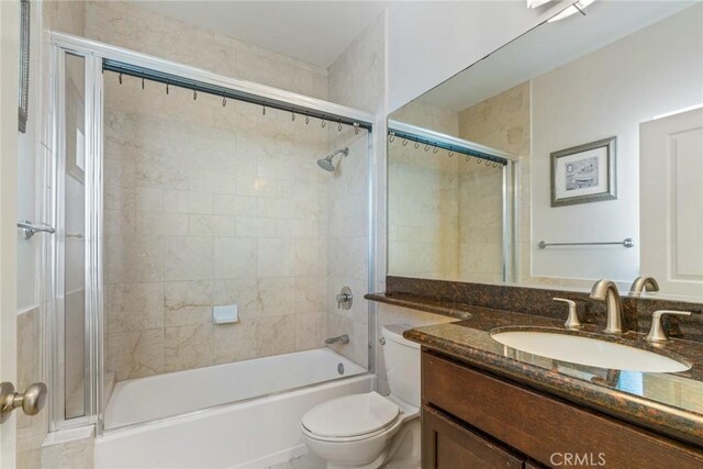 bathroom featuring toilet, vanity, and shower / bathtub combination