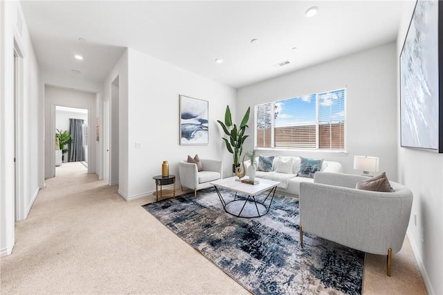 carpeted living area featuring recessed lighting, visible vents, and baseboards