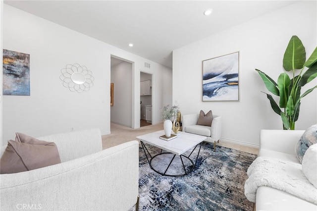 living area featuring recessed lighting, visible vents, light carpet, and baseboards