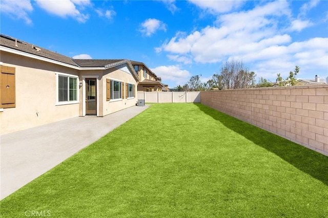 view of yard with a patio area, a fenced backyard, and central AC