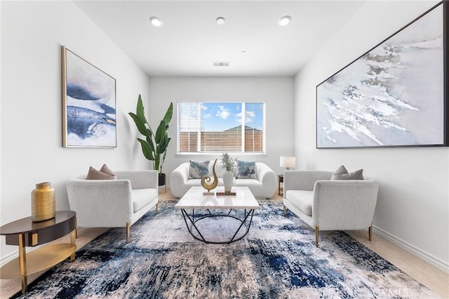 carpeted living area featuring recessed lighting, visible vents, and baseboards