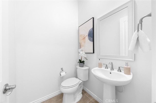 bathroom with tile patterned flooring, toilet, and baseboards