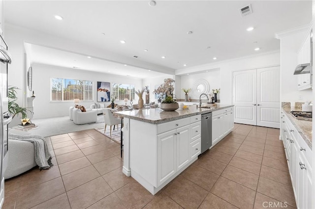 kitchen featuring white cabinets, recessed lighting, open floor plan, and stainless steel appliances