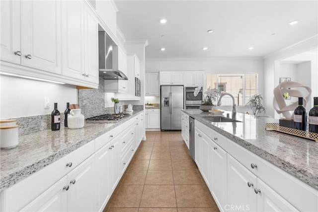 kitchen featuring ornamental molding, a sink, stainless steel appliances, wall chimney range hood, and light tile patterned floors