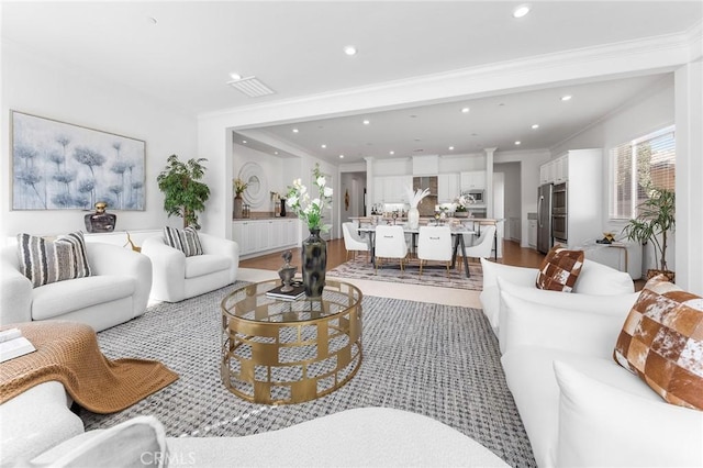 living area with recessed lighting, wood finished floors, and ornamental molding