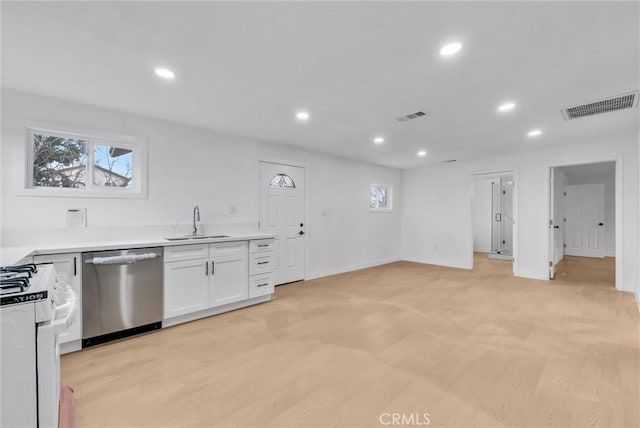 kitchen with visible vents, dishwasher, a sink, and white gas range