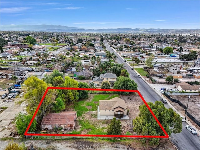 drone / aerial view featuring a residential view and a mountain view