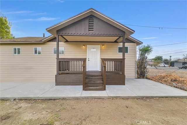 view of front of house featuring a patio area and fence