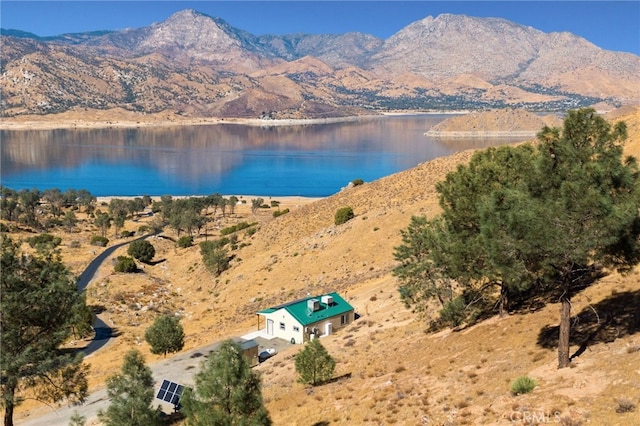 birds eye view of property with a water and mountain view