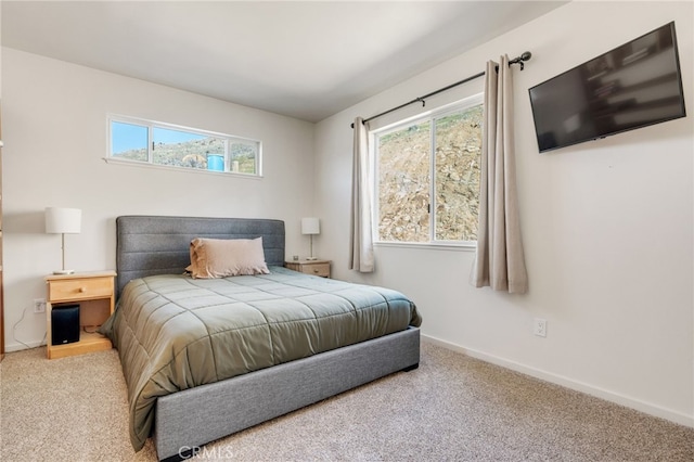 carpeted bedroom featuring baseboards